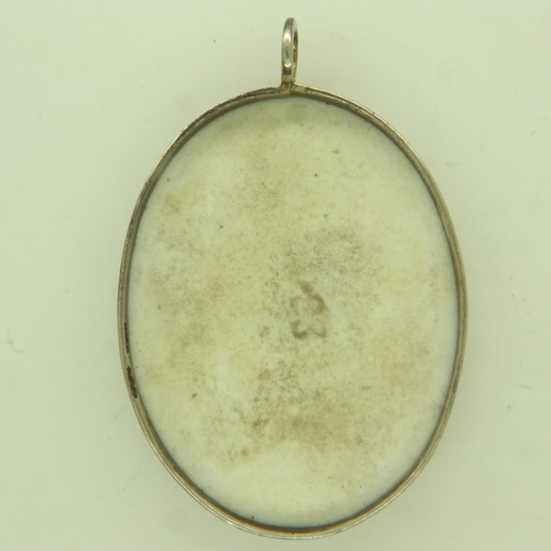 36 - A 19th century continental ceramic oval portrait, painted and enamelled, set into an oval pendant mo... 