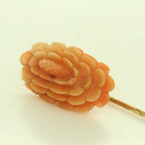7 - 9ct gold stick pin, mounted with a large panel of carved coral, L: 70 mm, 2.8g. UK P&P Group 0 (£6+V... 
