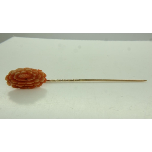 7 - 9ct gold stick pin, mounted with a large panel of carved coral, L: 70 mm, 2.8g. UK P&P Group 0 (£6+V... 