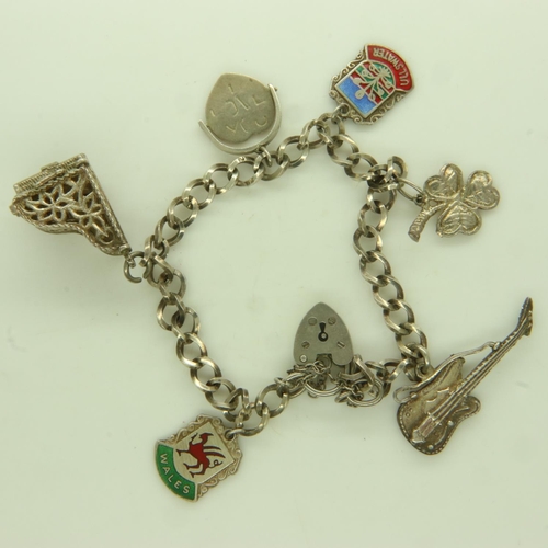 53 - 925 silver charm bracelet with six charms, 21g. UK P&P Group 0 (£6+VAT for the first lot and £1+VAT ... 
