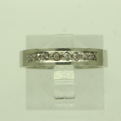 56 - Contemporary platinum band ring, channel-set with eight diamonds, size M/N, 5.4g. UK P&P Group 0 (£6... 