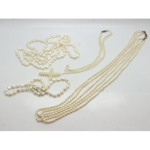 61 - Three freshwater pearl necklaces: one opera-length, a triple strand and a single strand example with... 