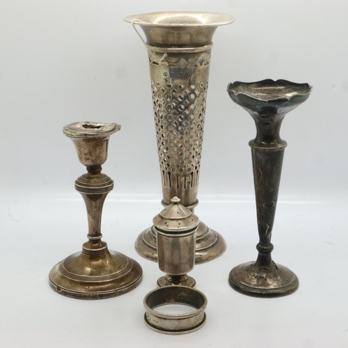 106 - Two hallmarked silver trumpet vases, napkin ring and pepperette, combined 191g, with a hallmarked si... 
