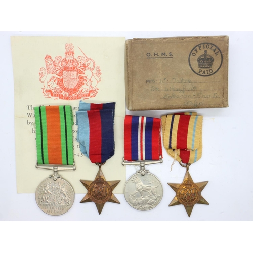 157 - British WWII Africa Star medal group of four, in box of issue addressed to Mrs Oakes of Stoke-On-Tre... 
