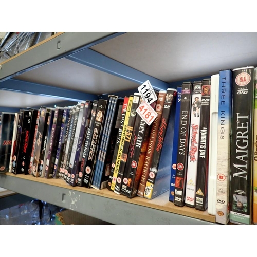 1194 - Shelf of mixed DVDs. Not available for in-house P&P