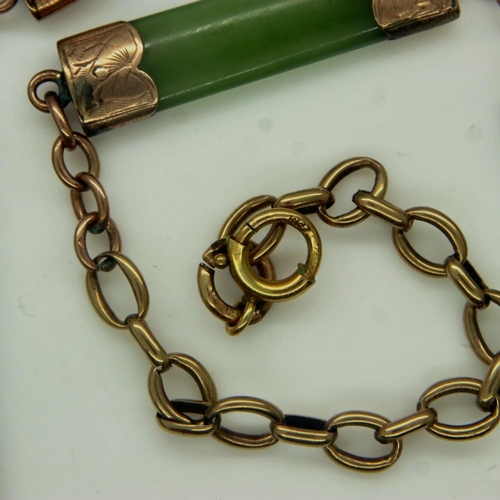 24 - An early 20th century 9ct gold necklace, the links separated with gold-mounted jade panels and a fur... 