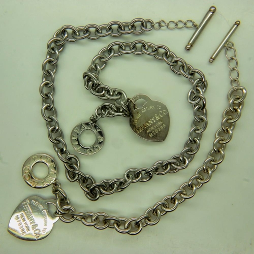26 - TIFFANY & CO: a suite of sterling silver jewellery, comprising a Heart Tag necklace, 67g, open L: 48... 