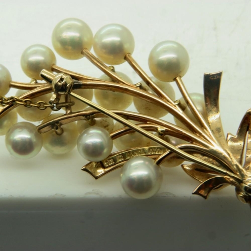 30 - MIKIMOTO: a 14ct gold floral design brooch, set with a multitude of cultured pearls, with safety cha... 