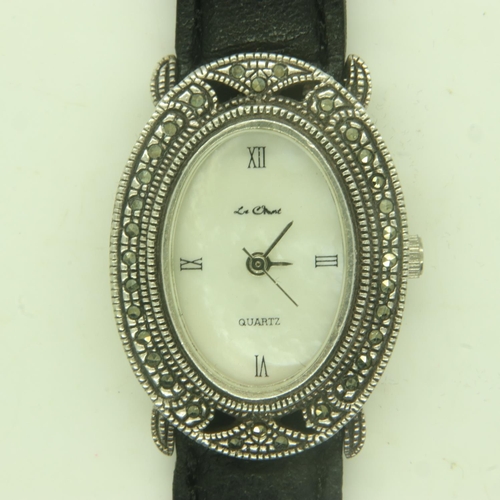 109 - LE CHAT: ladies silver cased wristwatch on a black leather strap, mother of pearl dial. UK P&P Group... 