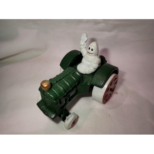 1025 - Cast iron Michellin Man on a tractor. H:80mm. UK P&P Group 1 (£16+VAT for the first lot and £2+VAT f... 