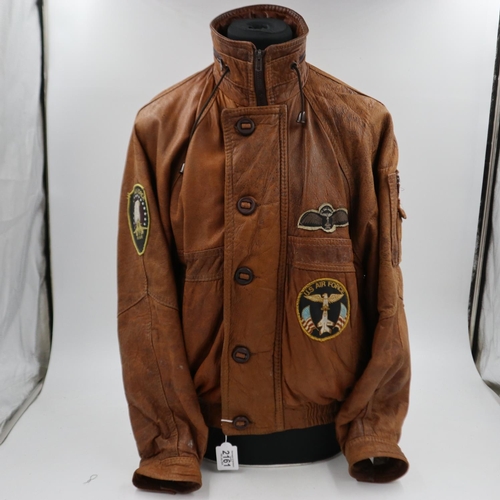 2161 - An American brown leather flying jacket, with sewn patches to the USAF, approximate size M. UK P&P G... 