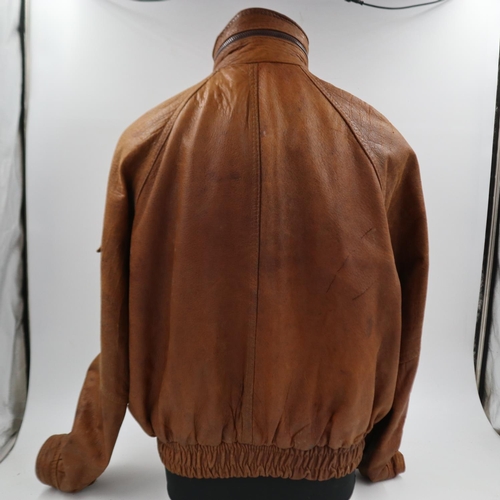 2161 - An American brown leather flying jacket, with sewn patches to the USAF, approximate size M. UK P&P G... 