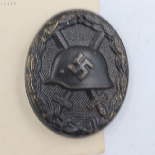 2243 - WWII German 3rd Class Wound badge in black (representing iron), with award certificate to a soldier ... 