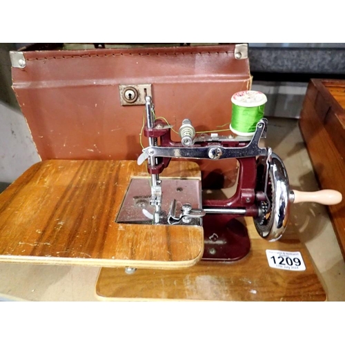 1209 - Small hand cranked sewing machine, no makers mark, in a case. Full working order. Not available for ... 