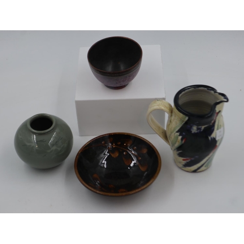 217 - Four pieces of studio pottery to include a jug, vase and two bowls, largest H: 16 cm. Not available ... 