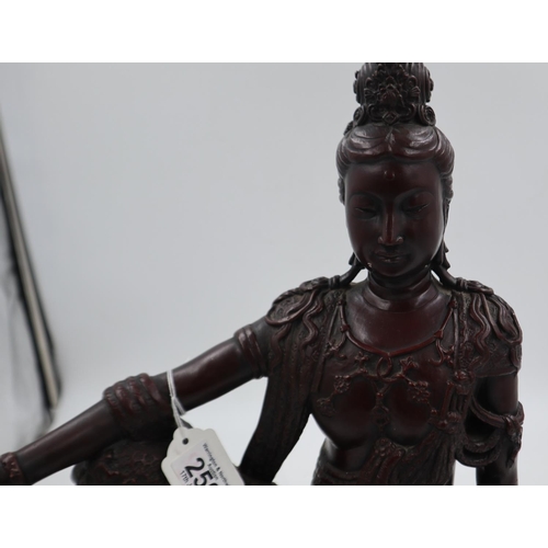 250 - Large bronzed figure of an Eastern deity sitting on a rock holding a ball in her right hand. Not ava... 