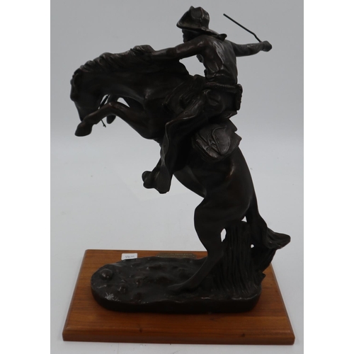 290 - Frederick Remington bronzed sculpture, The Bronco Buster, hand/whip repaired, H: 41 cm. Not availabl... 