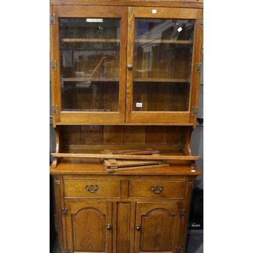 2052 - A 20th century country oak dresser, having a sideboard base and two-door glazed superstructure, 102 ... 