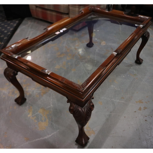 2061 - A modern rectangular centre table, the top of plate glass set into a heavily carved mahogany frame, ... 