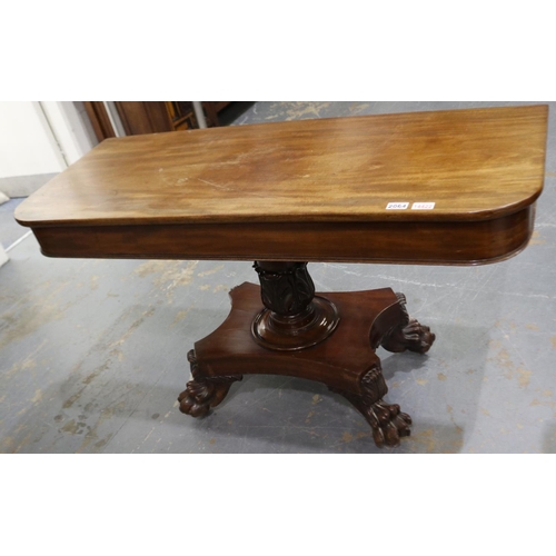 2064 - An early 19th century walnut console, with a heavily carved quadripartite support, formerly a fold-o... 