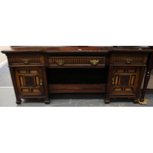 2068 - An Aesthetic period sideboard, break-front with single drawer flanked by two panelled and carved cup... 