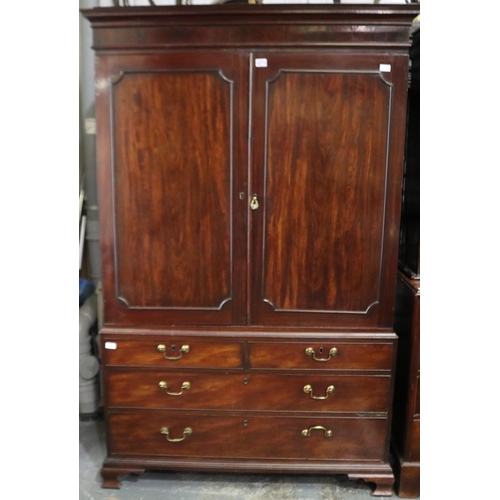 2070 - George III mahogany linen press, the base of two-short faux drawers and two long drawers supports th... 