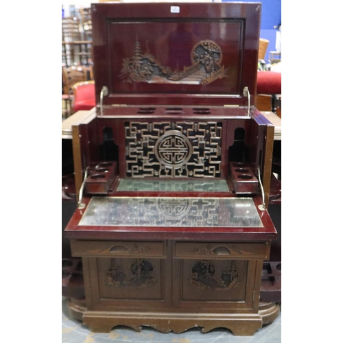 2083 - A 20th century carved hardwood Chinese drinks cabinet, with metamorphic opening, fitted interior and... 