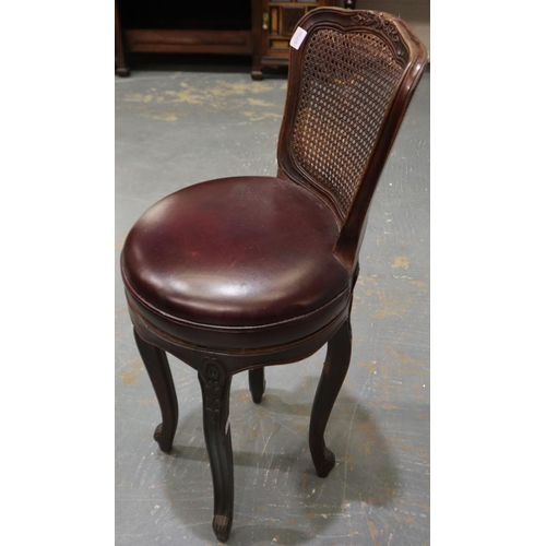 2087 - An early 20th century bistro bar stool, with swivel circular seat and bergère back rest, D: 45 cm, H... 