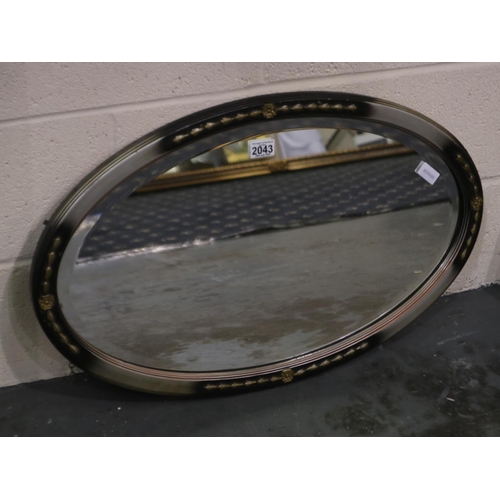 2043 - An early 20th century oval wall mirror, later painted frame with bevelled glass, overall 75 x 47 cm.... 