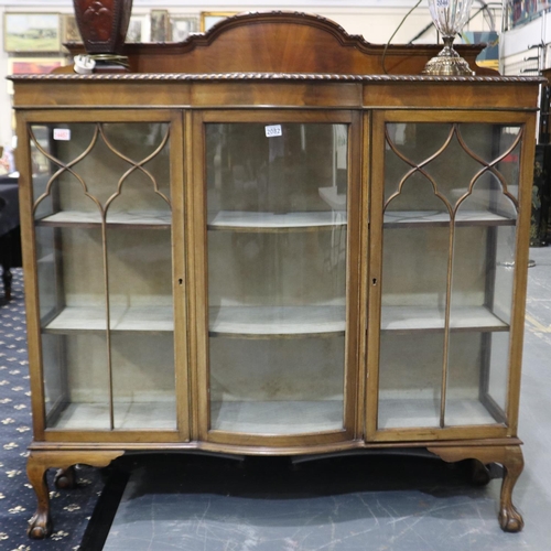 2082 - An early 20th century three-door walnut glazed display cabinet, central bowed panel flanked by two d... 