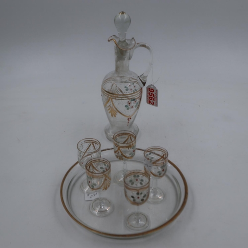 284 - Victorian liqueur decanter and five glasses with gold detail and enamel flowers with glass tray. Not... 