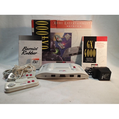 2166 - Boxed Amstrad GX4000 with Burnin' Rubber game, PSU, two controllers and paperwork, powers up and lig... 