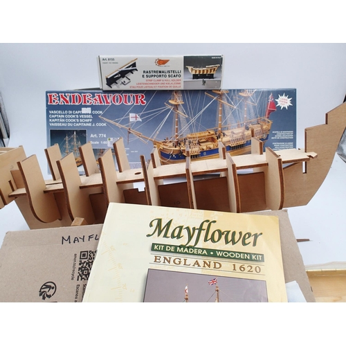 2456 - Two wooden ship kits, Mayflower, Endeavour etc, part built, contents unchecked, plus build clamp too... 