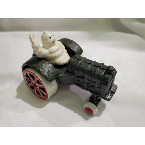 1109 - Cast iron Michelin Man on a tractor, H: 80 mm. UK P&P Group 1 (£16+VAT for the first lot and £2+VAT ... 