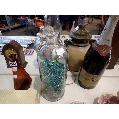 1366 - Large whiskey bottle containing glass beads. Not available for in-house P&P