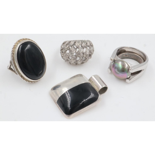 44 - Three heavy-gauge 925 silver rings (two stone set), a silver band ring and a stone set silver pendan... 