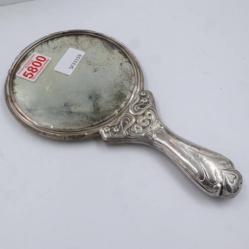 76 - An Art Nouveau hallmarked silver hand mirror, with figural design in relief, plaster filled, marks i... 