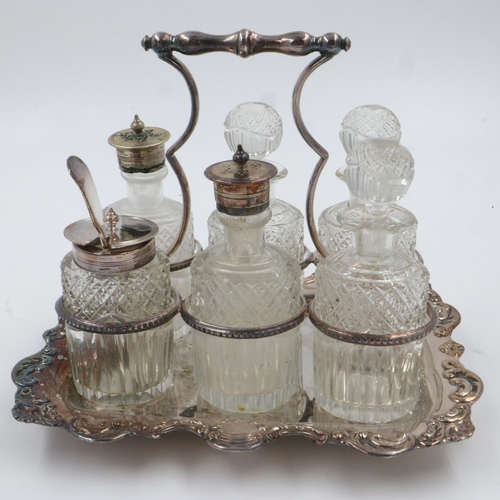 88 - A silver plated table cruet, having six cut glass receptacles with plated mounts on a tray, some chi... 