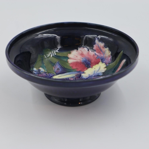 205 - Moorcroft footed bowl in the Orchid pattern, on a cobalt blue ground, 16.5cm D. UK P&P Group 1 (£16+... 