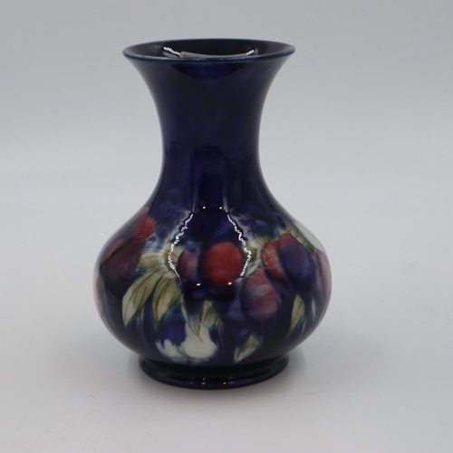 216 - Moorcroft vase in the Wisteria pattern, on a cobalt blue ground, chip to base rim, 20cm H. UK P&P Gr... 