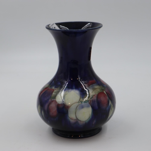 216 - Moorcroft vase in the Wisteria pattern, on a cobalt blue ground, chip to base rim, 20cm H. UK P&P Gr... 