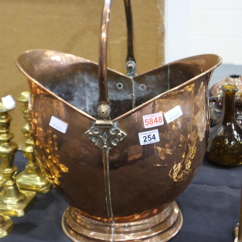 254 - An oversized 19th century copper helmet-form coal bucket with hinged handle, H: 40 cm (exc. handle).... 