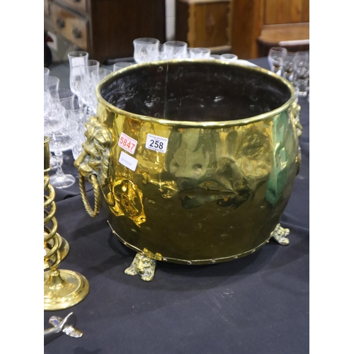 258 - A large Victorian brass coal bucket with lion-mask handles and cast supports, H: 33 cm. Some dents t... 