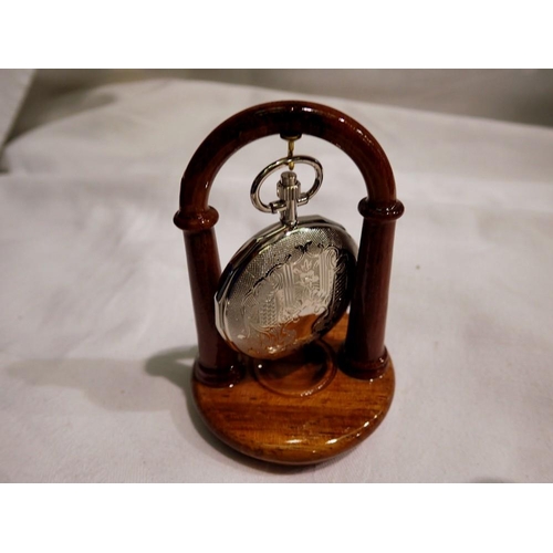 1064 - Pocket watch presented on wooden stand - working at lotting up. UK P&P Group 1 (£16+VAT for the firs... 