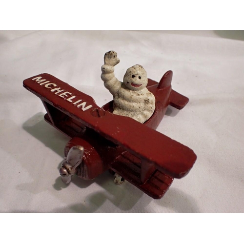 1087 - Cast iron Michelin Man in a plane, H: 80 mm. UK P&P Group 1 (£16+VAT for the first lot and £2+VAT fo... 