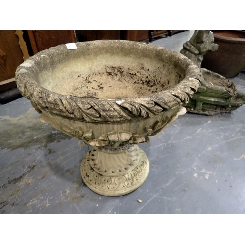 1810E - A large reconstituted stone urn on pedestal, decorated in relief, D: 54 cm, H: 51 cm. Not available ... 