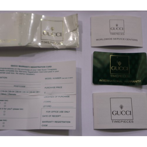 73 - GUCCI: ladies quartz wristwatch with changeable coloured bezels, boxed with guarantee card from Bood... 