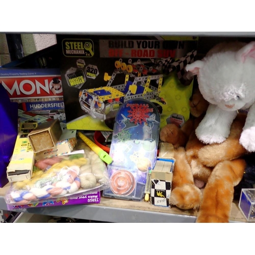 1025 - Shelf of plush toys and games, including Steel Mechanix and Monopoly. Not available for in-house P&P