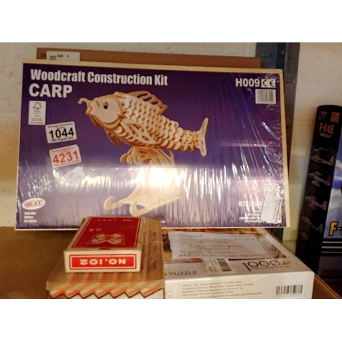 1044 - Woodcraft construction kit carp, 2x 1000pc jigsaws and a pack of cards with travel dominoes. Not ava... 