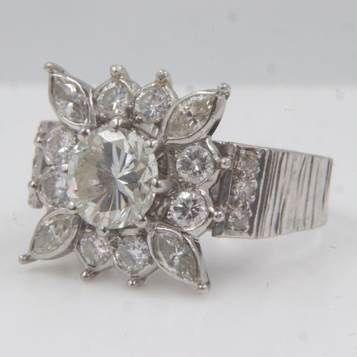 31 - Large heavy gauge diamond-set platinum cocktail ring, the central cushion-cut stone approximately 1.... 